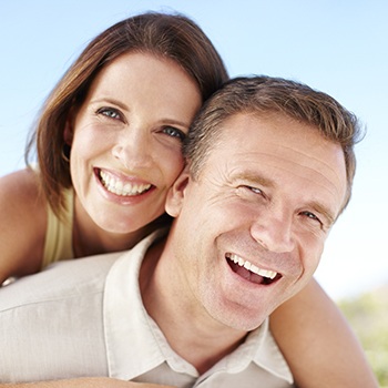 Older man and woman smiling together outdoors