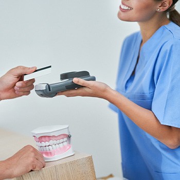 A man paying for dental treatment