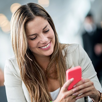 Smiling woman looking at cellphone