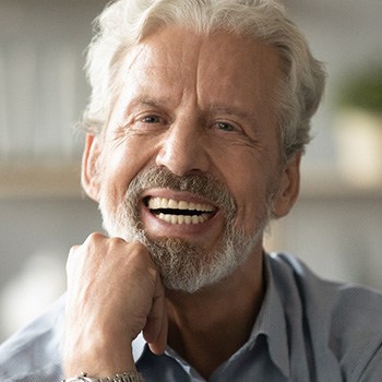 A smiling elderly man looking at the camera