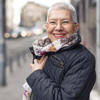 Woman smiling with dentures in Dallas