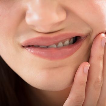 Closeup of woman experiencing tooth pain