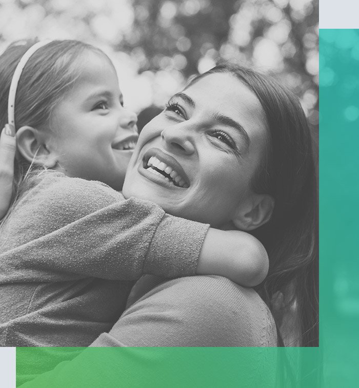 Smiling mother holding her daughter