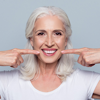 woman smiling after visiting dental implant dentist in Dallas