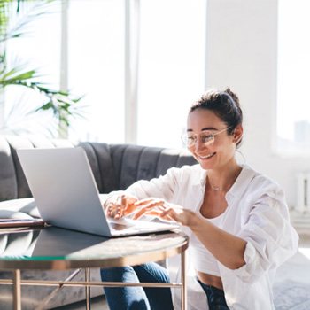 Woman smiling while working at home