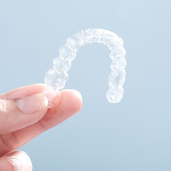 Patient holding up clear aligner