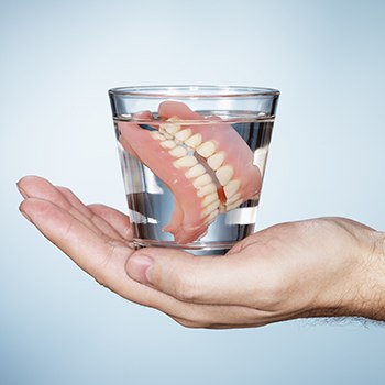 Full denture in glass of water