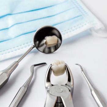 Tools holding tooth after tooth extraction in Dallas