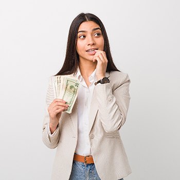 a woman holding money and thinking in Dallas