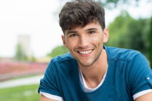 A young man smiling.