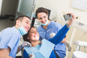 happy patient taking selfie at the dentist