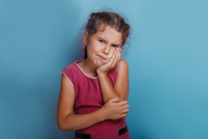 Girl with toothache needing to see dentist