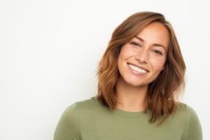 Woman wearing a green top smiling 